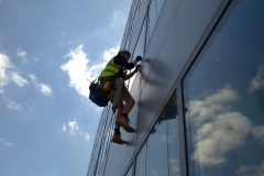 Rope Access technician cleaning windows