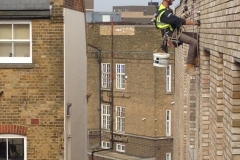 Abseiler on side of building