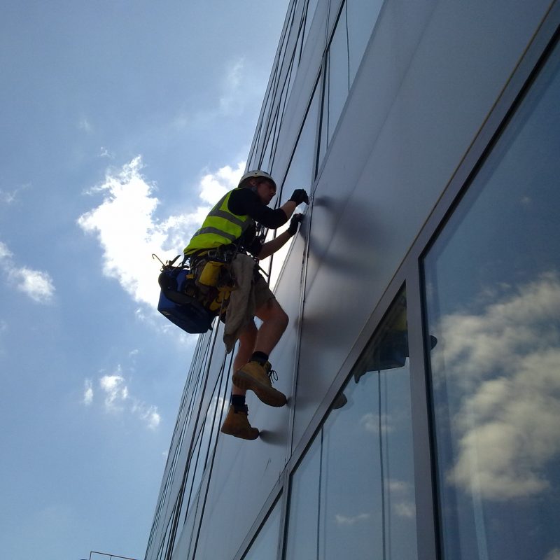 Rope Access technician cleaning windows